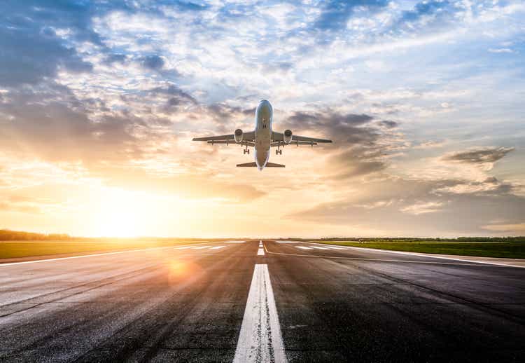 Passenger airplane taking of at sunrise